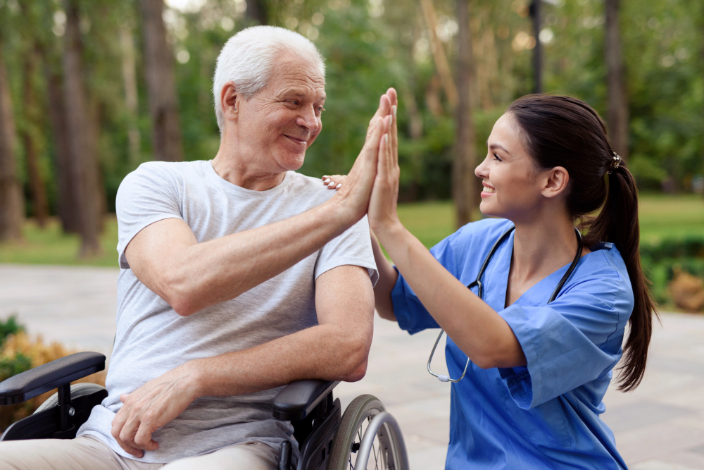 nurse-old-man-wheelchair-high-five (1)